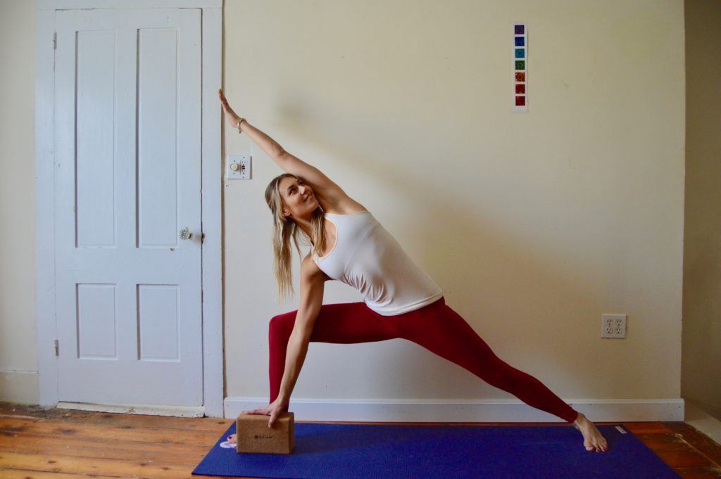 Woman in side angle pose, one of our favorite yoga poses for skiers