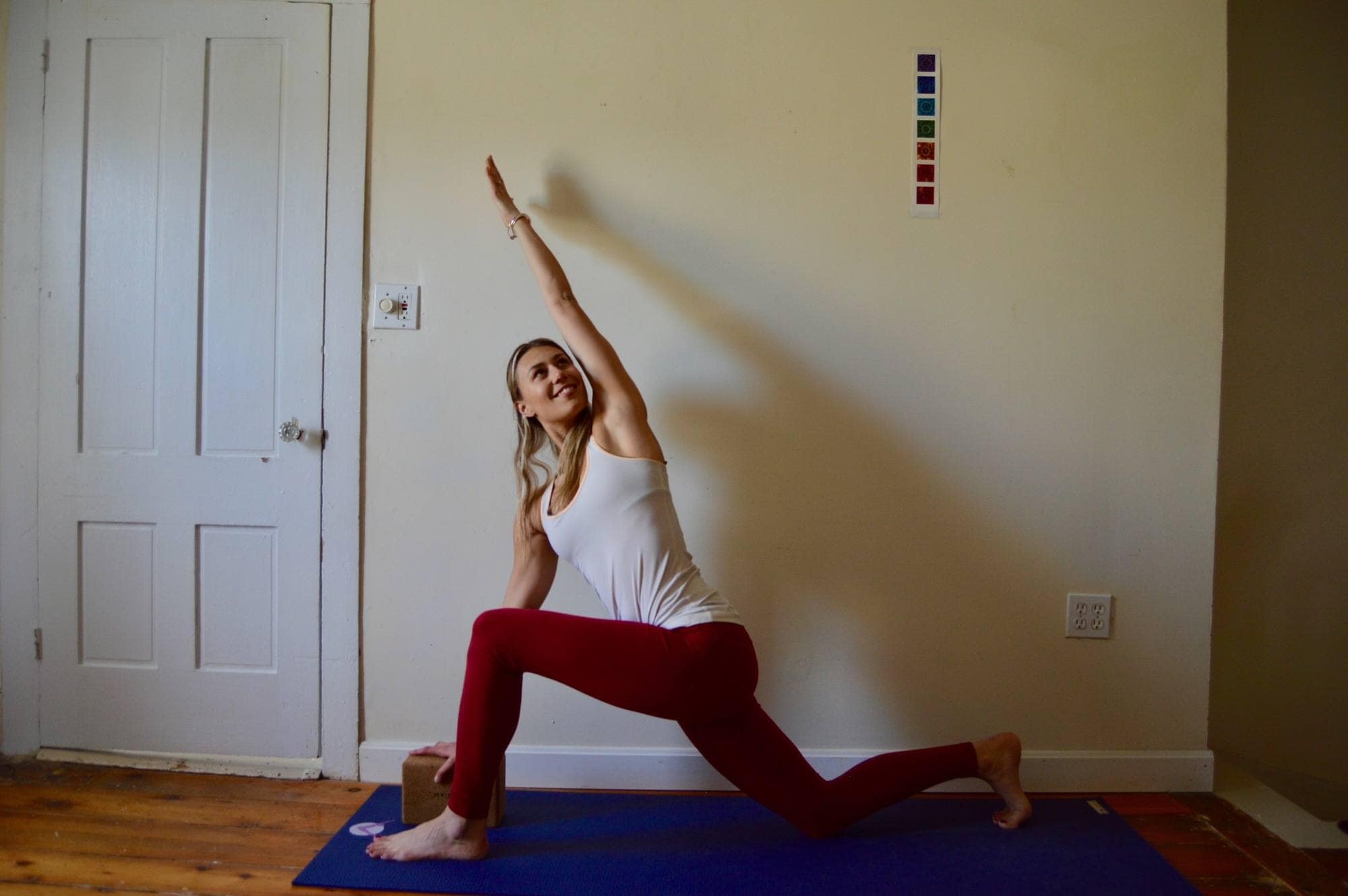 Woman holding a yoga pose on the floor with a twist, demonstrating yoga for skiing