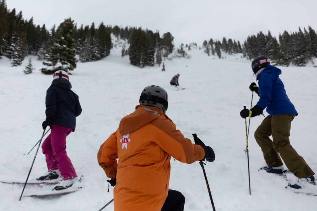 Three skiers on the slopes in winter