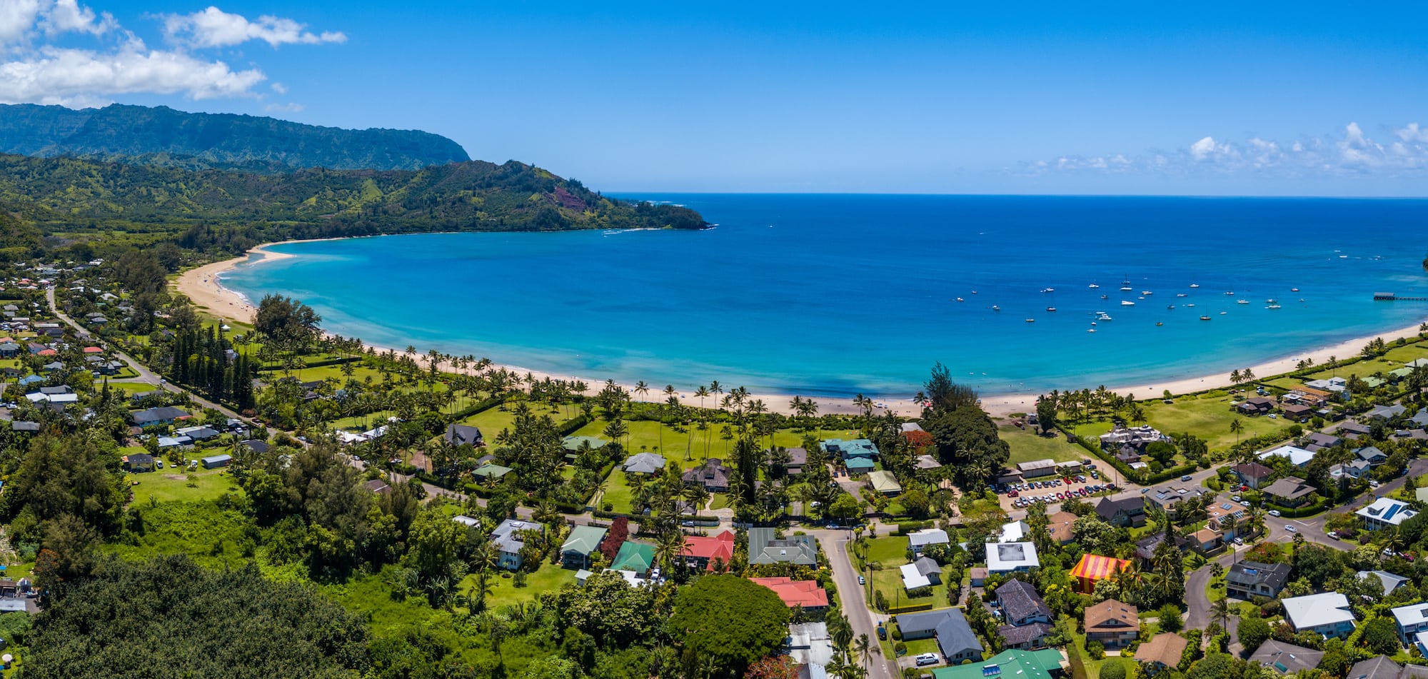 Hanalei Bay // Discover the best things to do in Kauai for outdoor adventurers including scenic waterfall hikes, secluded beaches, water activities, & more!