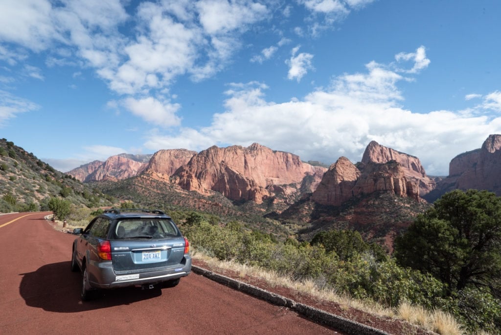 A blue Suburu pulled off the road on a road trip in Utah