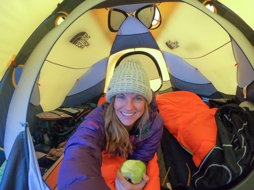 Kristen taking selfing inside tent with cold weather camping gear