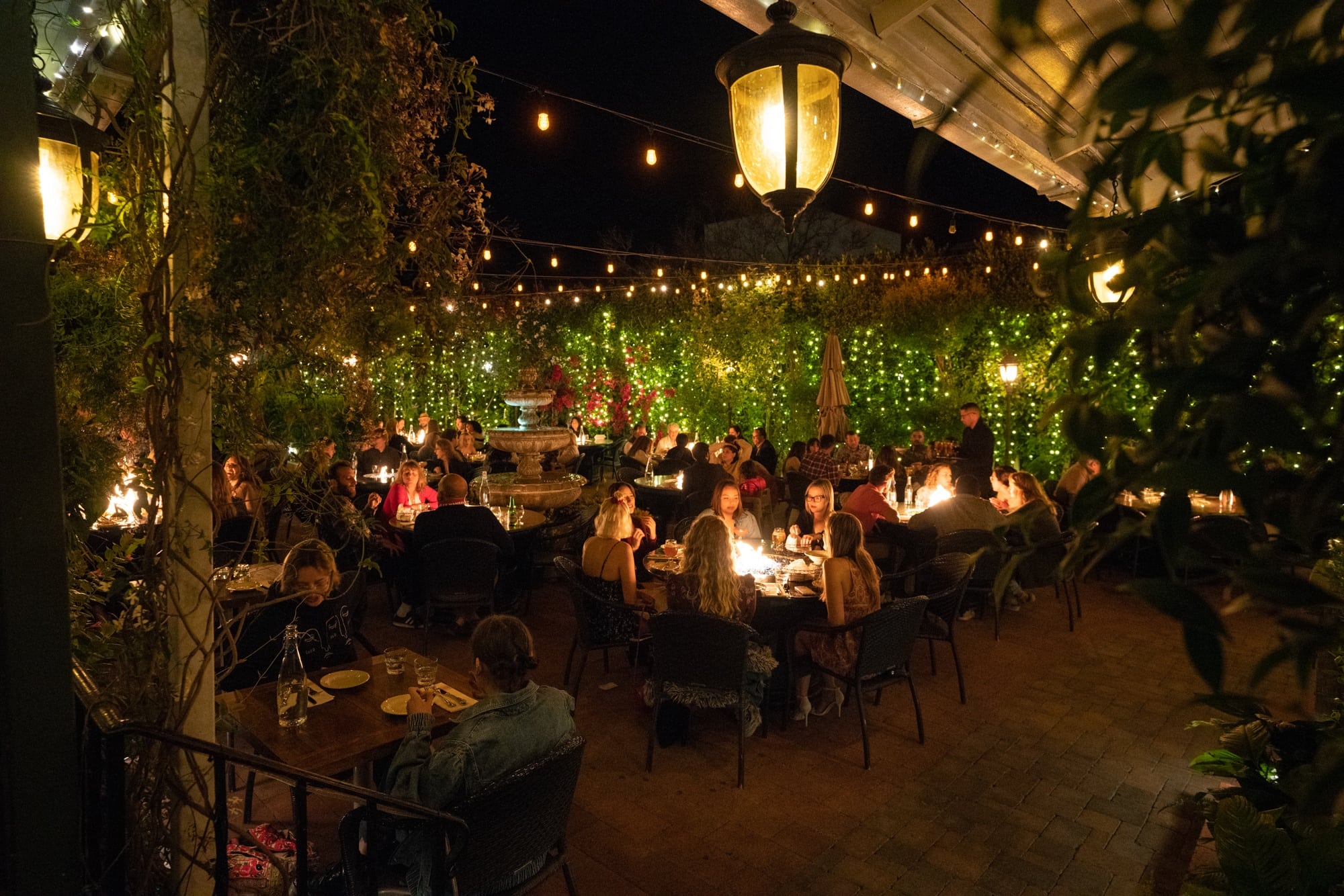 Outdoor dining at Zaytoon Restaurant in Santa Barbara lit up with lights