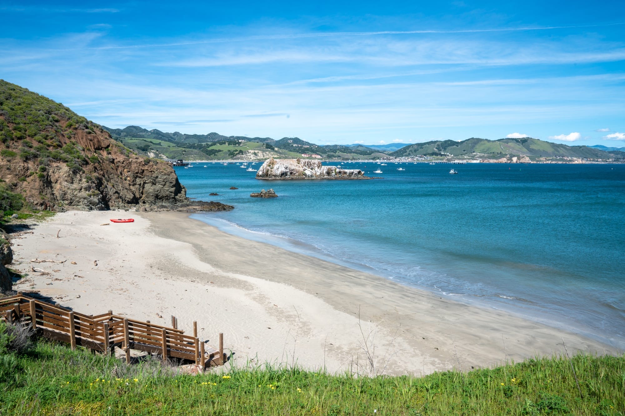 Lone kayak pulled up on a sandy beach near Avila, California