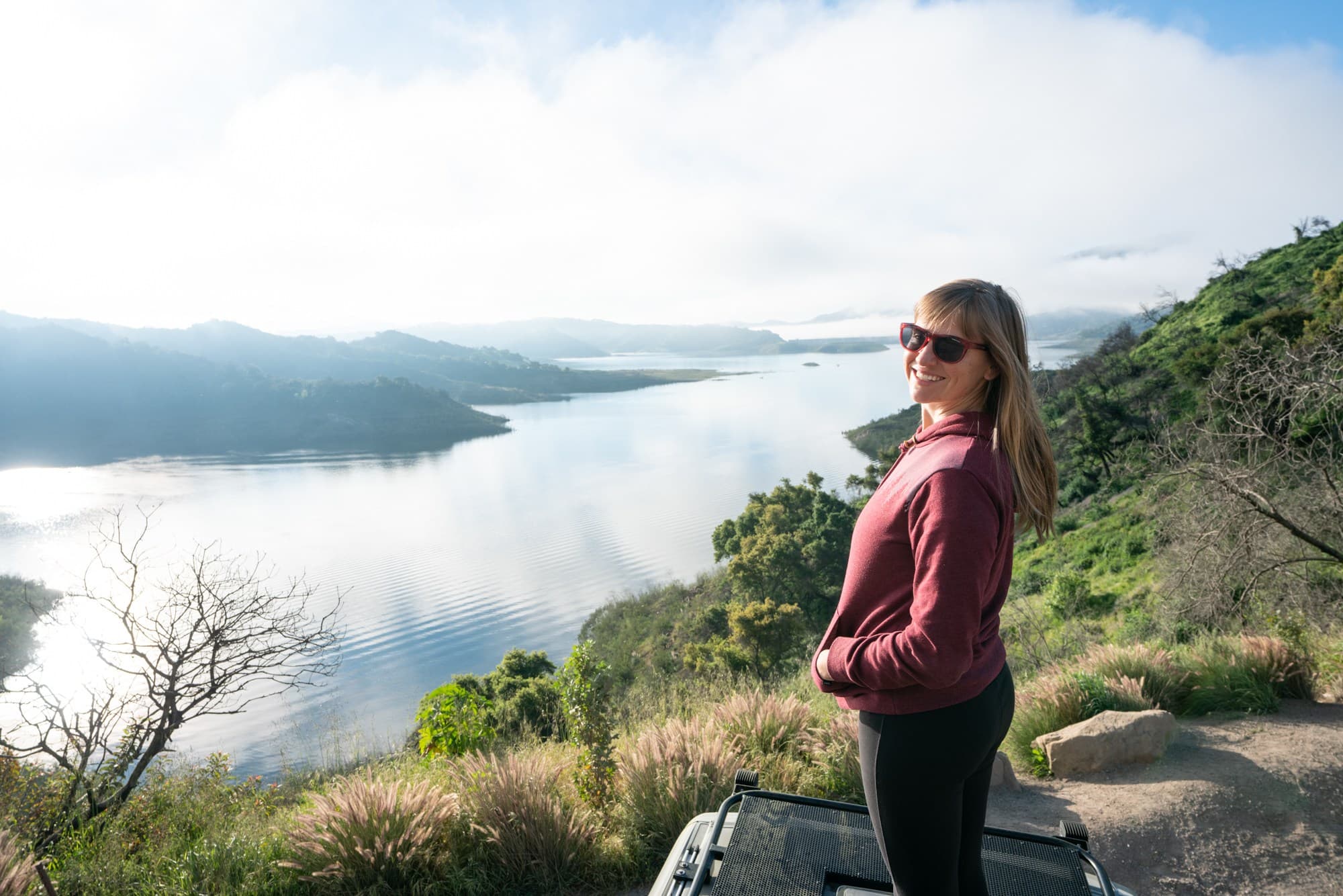 Woman standing at beautiful overlook of Lake Casitas near Ojai, California