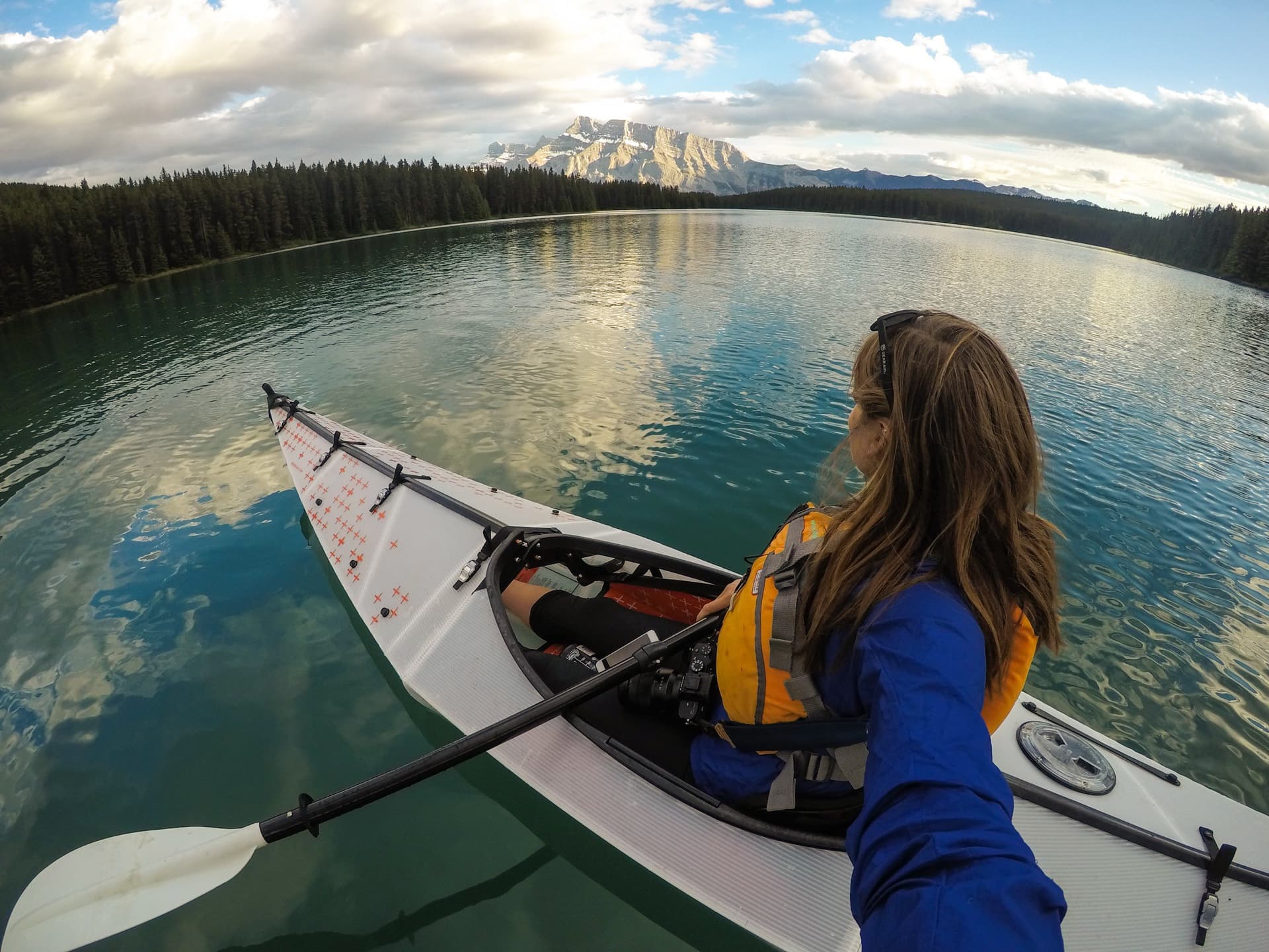 a woman kayaking on Two Jake Lake in Banff