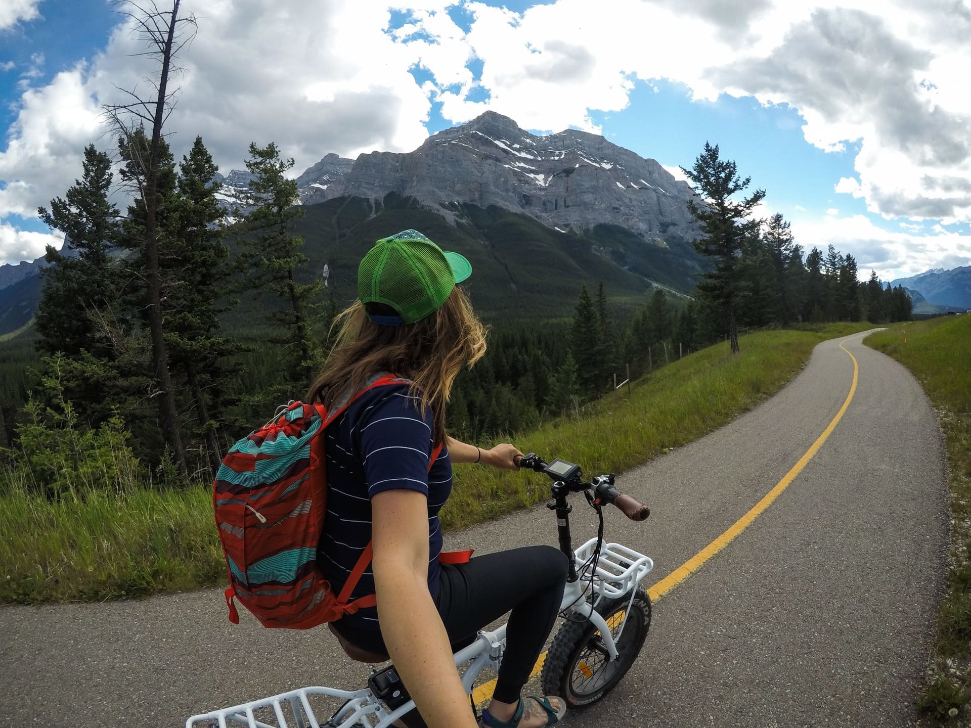 woman biking the Banff Legacy Trail in Canada during the summer