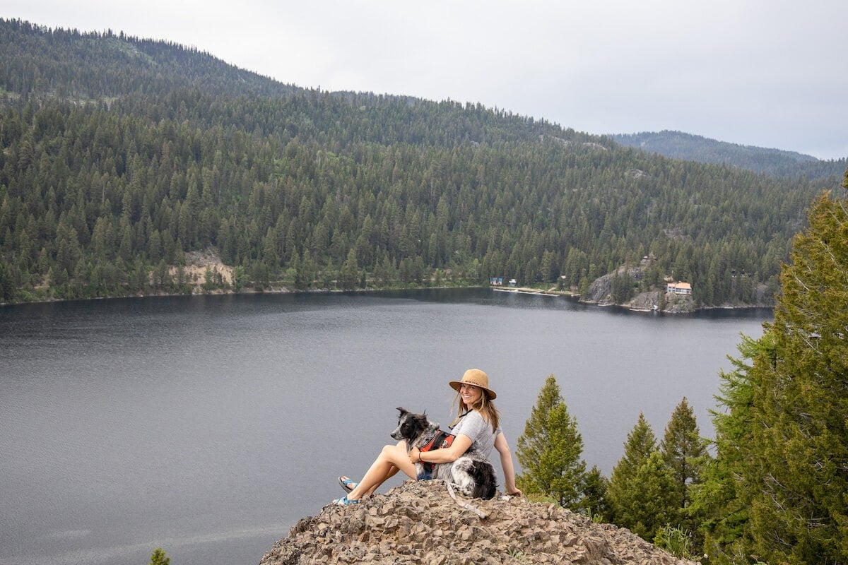 woman sitting on a rock overlooking a lake at Ponderosa State Park in McCall, Idaho