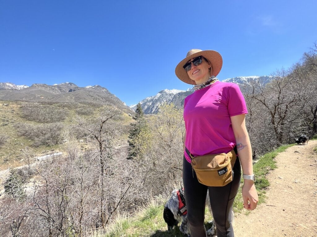 Kristen on a hike with her dog wearing a lululemon clean lines belt bag