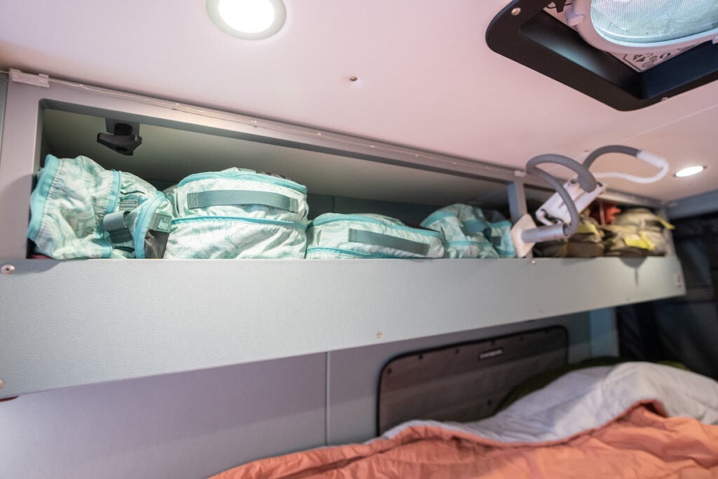 Cupboards in van 'closet' filled with packing cubes of clothes