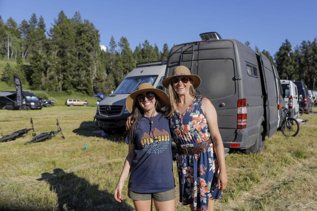 Kristen Bor and woman standing next to vans at Open Roads Fest