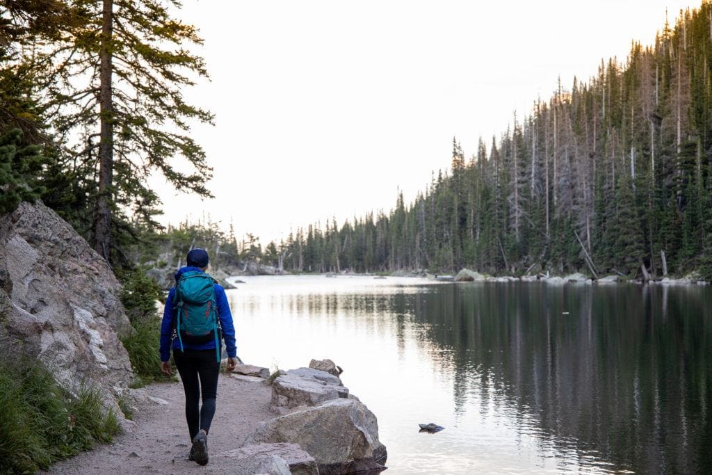 Kristen hiking on lakeside trail