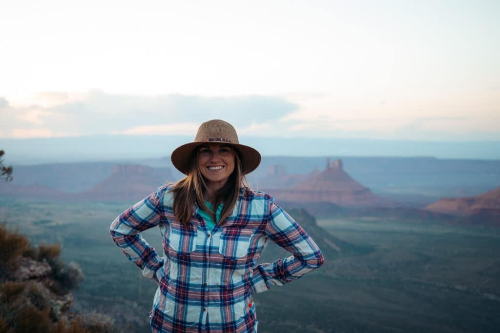 Woman standing on cliff at Porcupine Rim Campground in Moab Utah