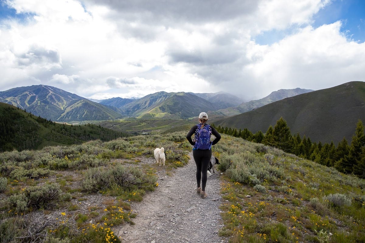 Kristen Bor hiking on a cloudy day in Sun Valley with bald mountain in the distance