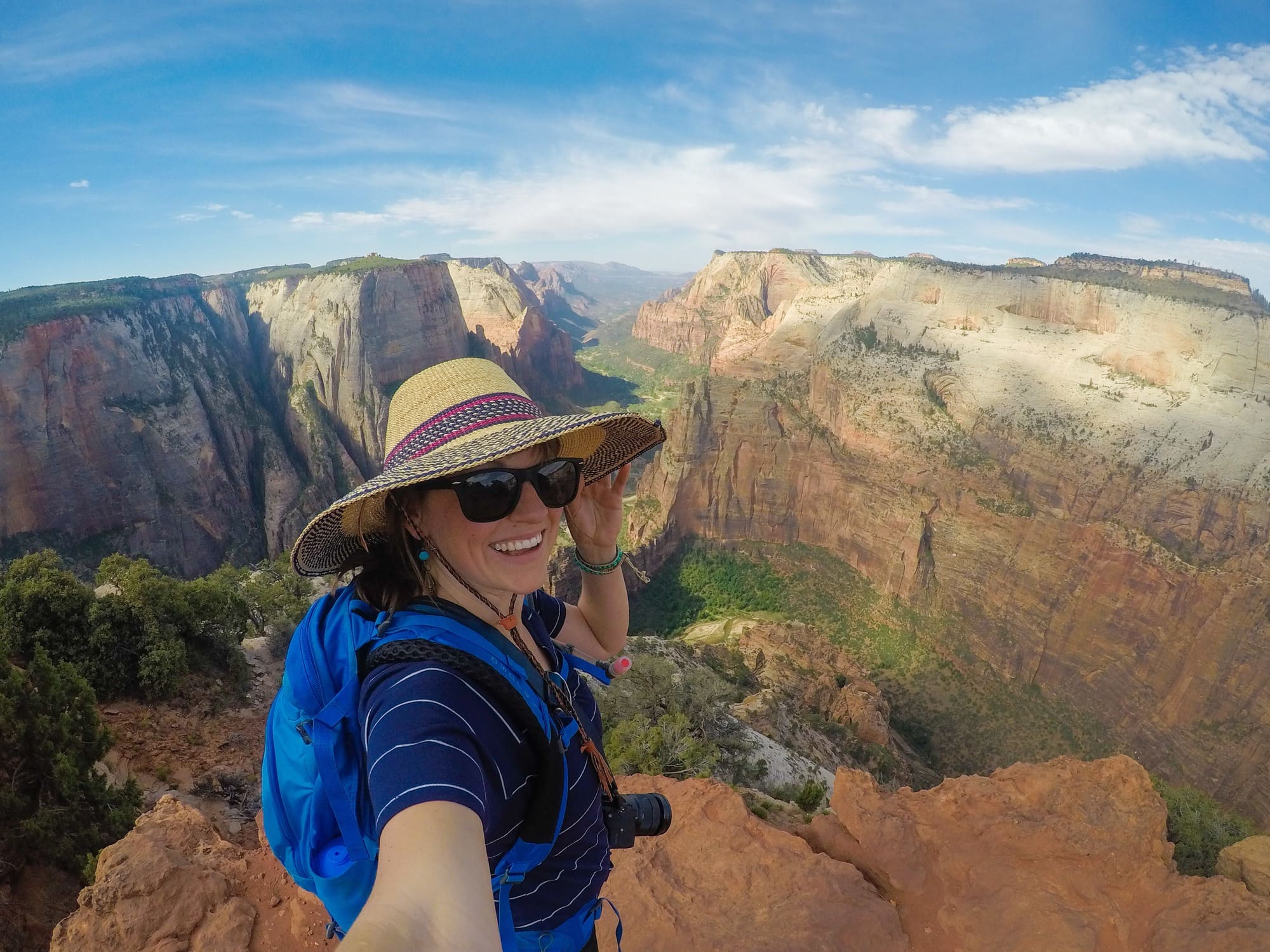 Kristen taking a selfie photo with Utah canyon landscape behind her