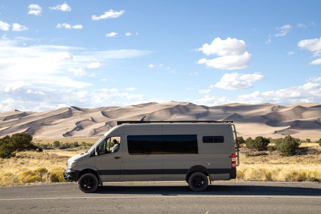 A Sprinter van parked on the side of the road at Great Sand Dunes National Park in Colorado