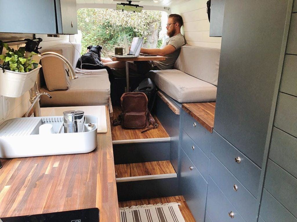 Raised dinette convertible van bed