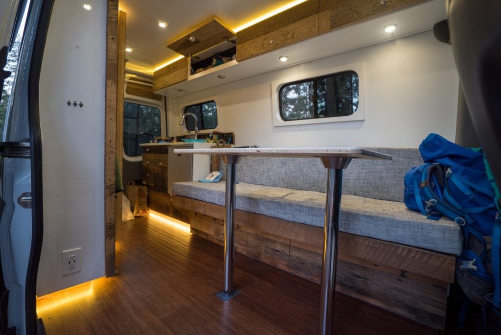 the interior of a camper van with a table with a removable base