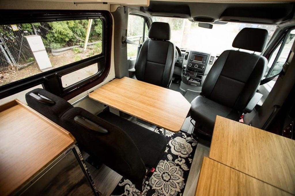 an above shot of the interior of a campervan including a pop up table on a hinge