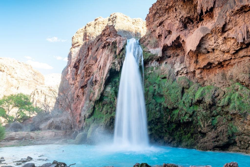 Turquoise blue waterfall and pool at Havasu Falls in Arizona