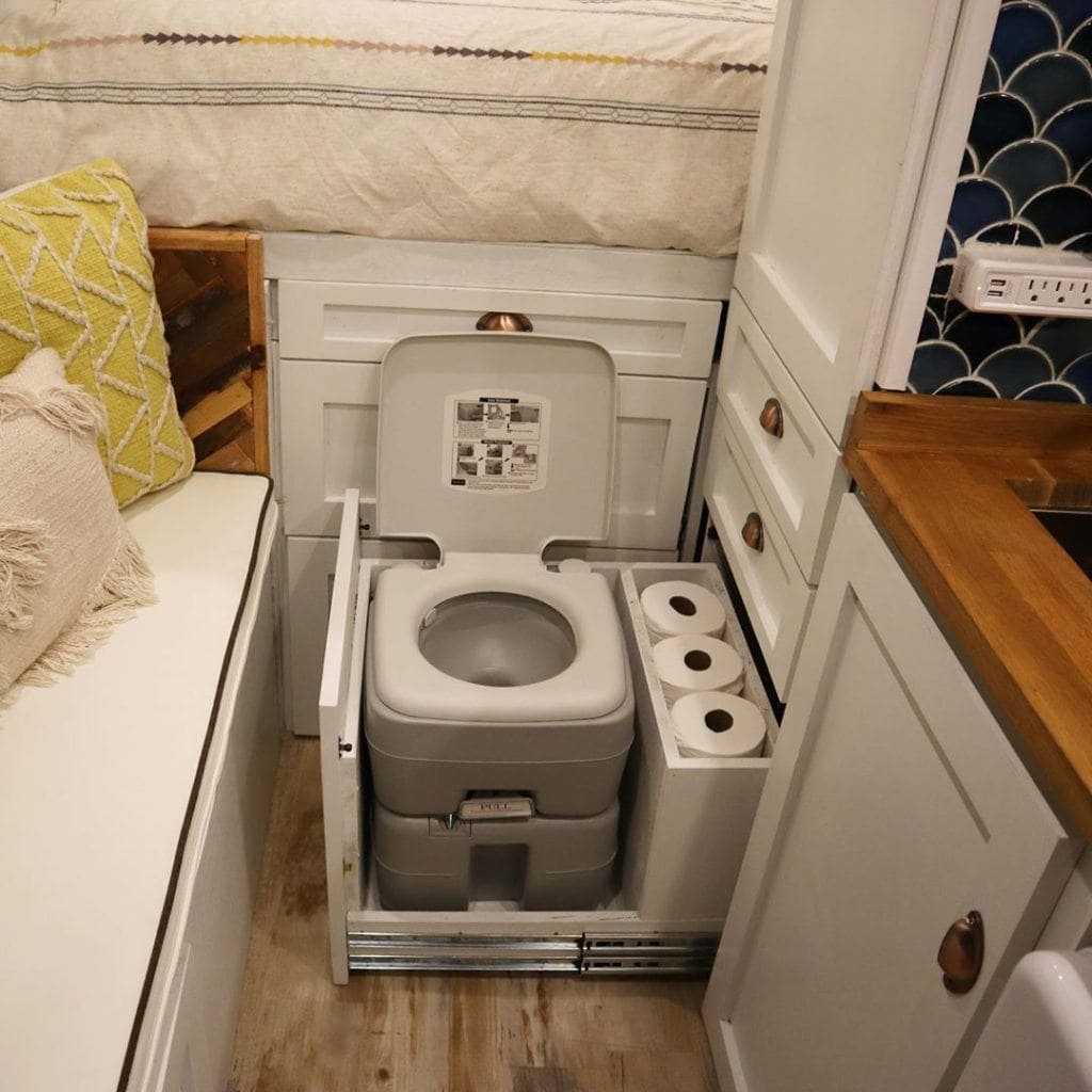 Hidden camper van toilet by @lightravelers