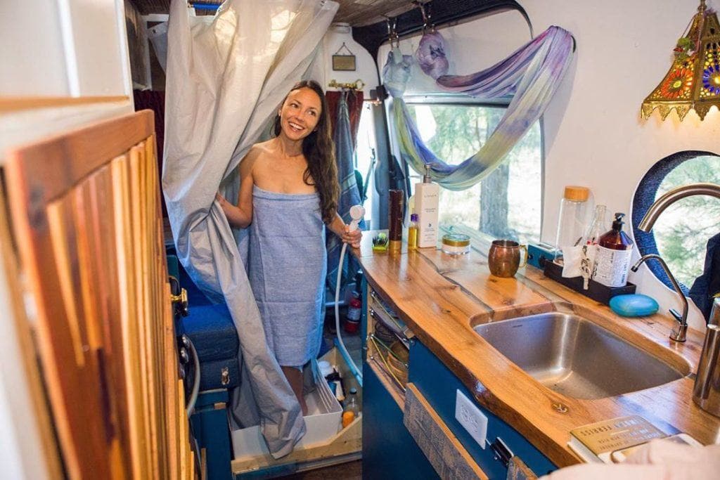 Hidden drawer camper van shower by @mrandmrsadventure