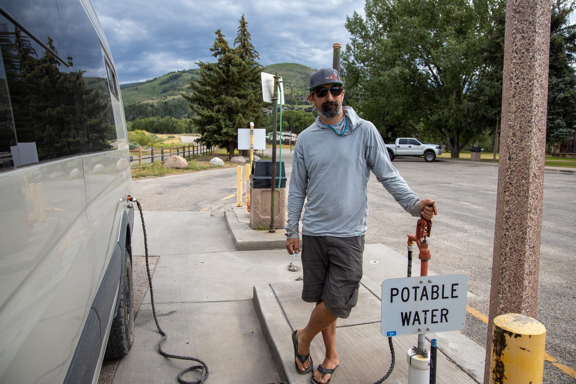 Man filling up sprinter van water tank