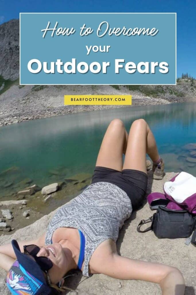 Woman lying next to lake on a rock. Text reads How to Overcome your outdoor fears