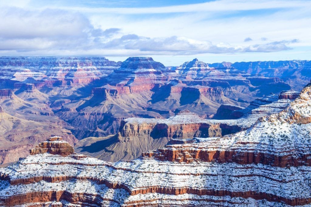 Landscape view out over the Grand Canyon National Park in winter with light dusting of snow