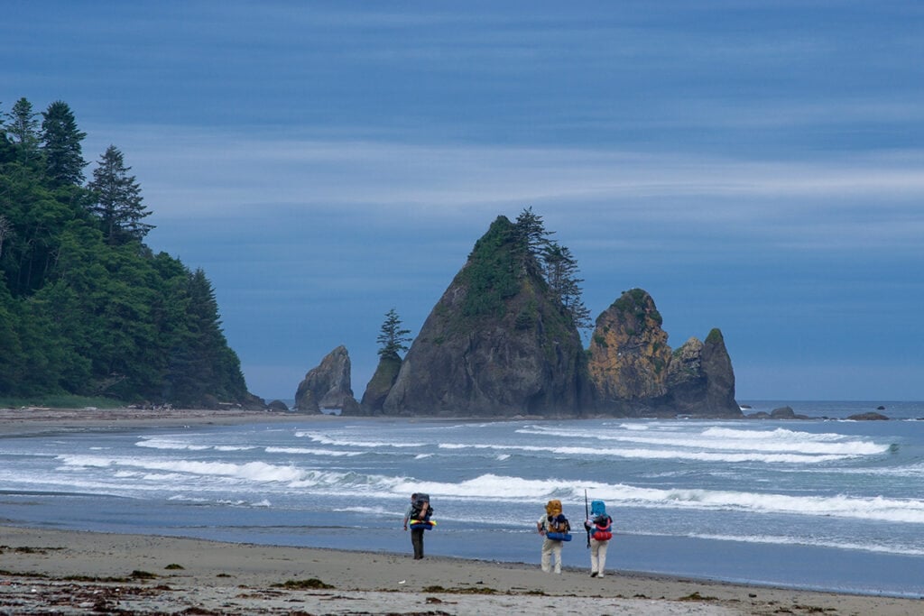 People walking on beach in Washington just after sunset. 