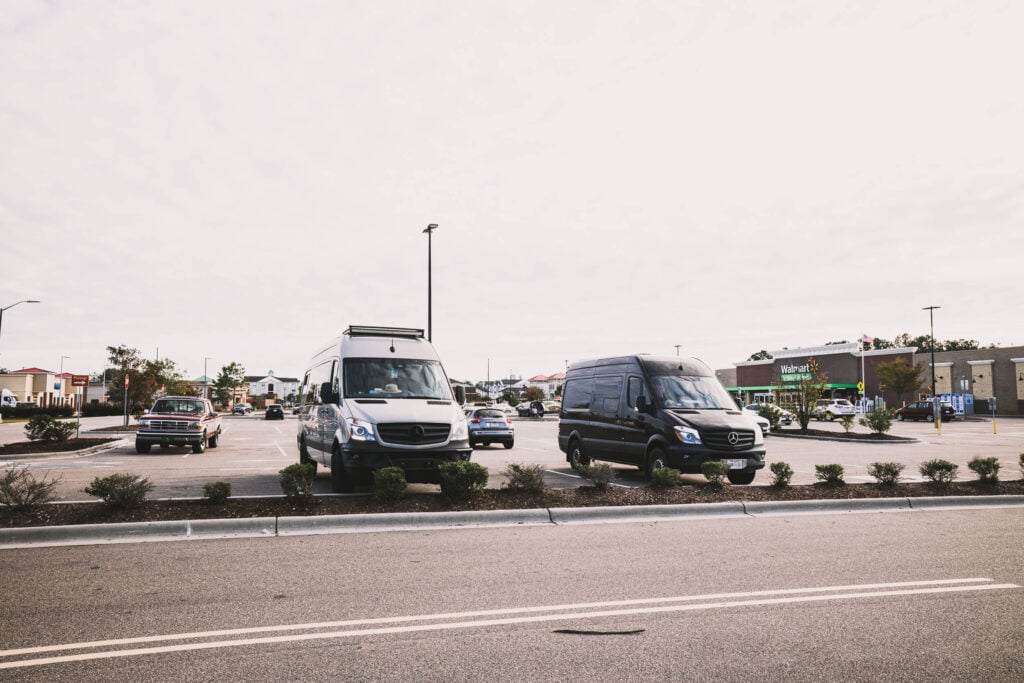 Two Sprinter vans are parked outside of a Walmart in North Carolina