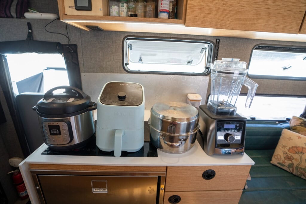 Instapot, air fryer, nesting cookware and a vitamix on the counter in the rossmonster baja trail adventure truck