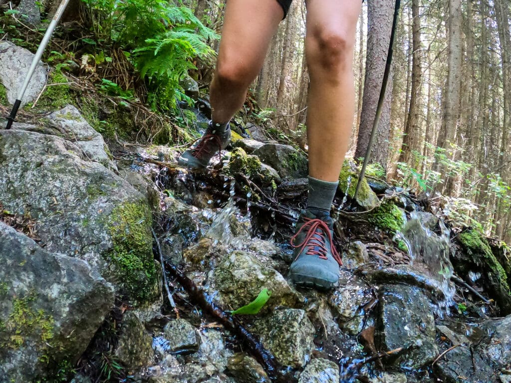 Close up of women's feet hiking wearing Oboz hiking boots and Darn Tough Socks