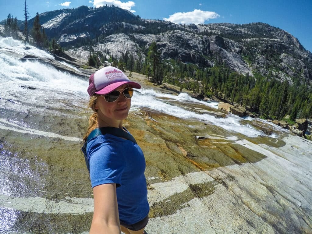 Kristen Bor standing next to a waterfall in Yosemite National Park