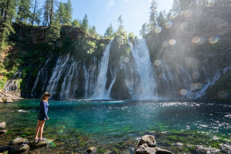 Kristen Bor standing at the base of Burney Falls in California