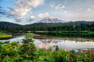 Landscape photo of snow-capped Mount Rainier with lake in foreground