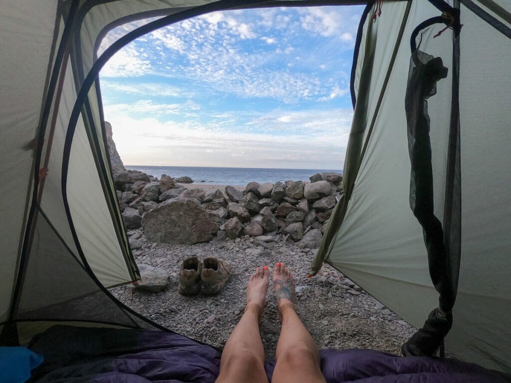 Photo from inside tent out onto rocky beach on Catalina Island in California