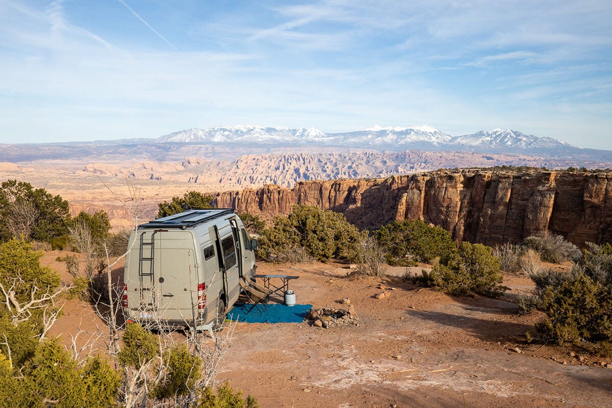 Sprinter van parked at free dispersed campsite overlooking La Sal mountains in Moab