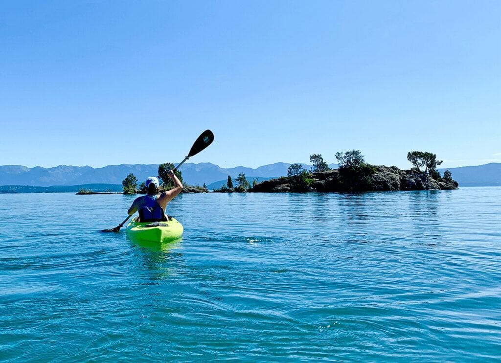 Kintla Lake / Learn the best kayak camping tips for beginners including essential kayak camping gear, how to pack a kayak, tips for buying a kayak, & more.