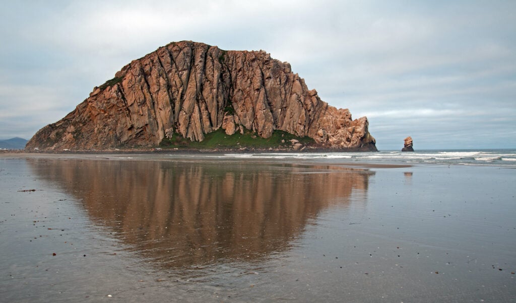 Morro Rock // Learn about 12 of the best California beach campgrounds with tent/RV sites right on the coast in Northern, Central, and Southern California.