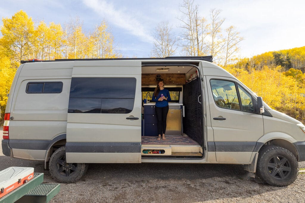 Kristen in her Sprinter // Learn what to consider when buying a new vs used van for van life, tips for buying a van, and where to search for your perfect van.