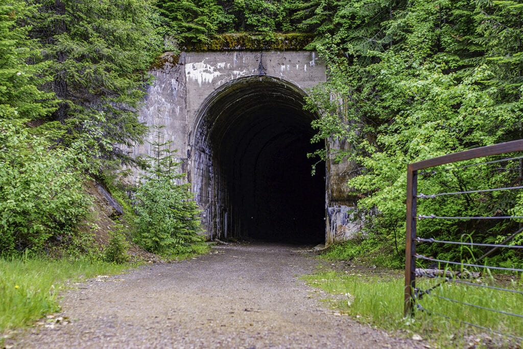 Hiawatha trail tunnel // Plan your biking adventure in Idaho with this complete guide. Discover route tips, where to rent bikes, and more.