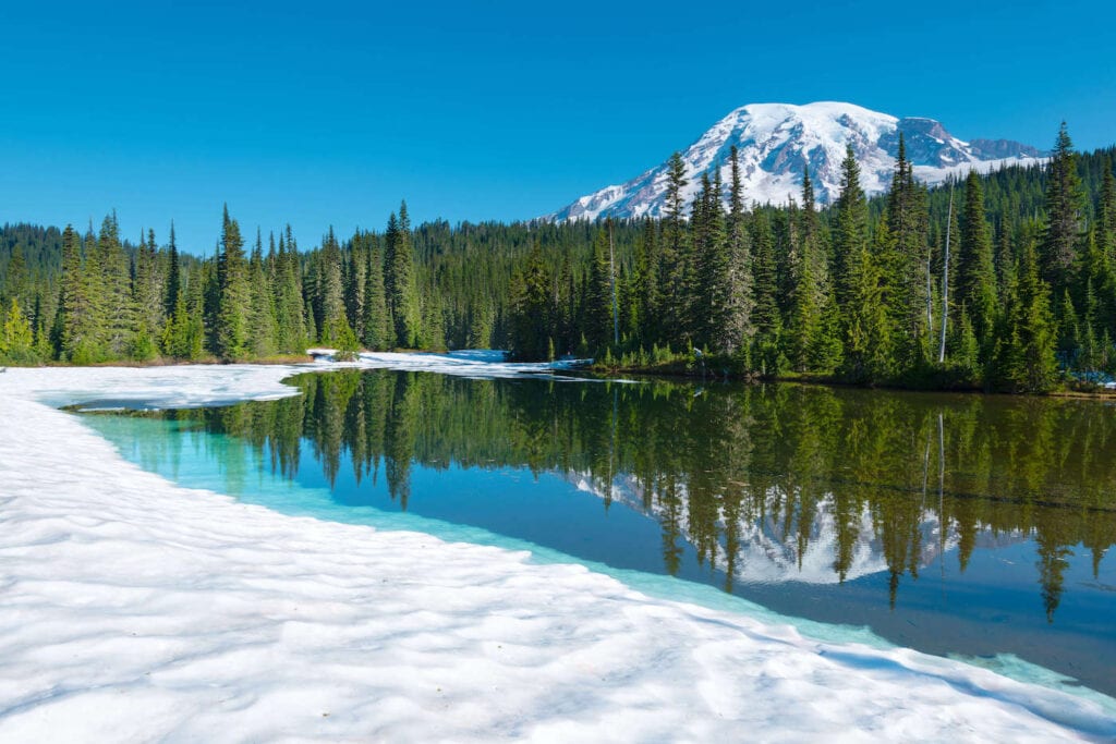 Mt. Rainier // Discover the best snowshoeing destinations west of the Rockies that are perfect for a winter snowshoeing getaway without the crowds.