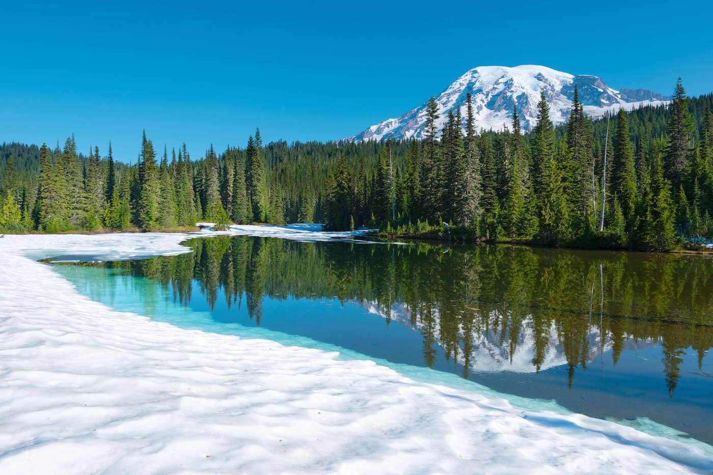 Snowy scene at Reflection Lake in Mt Rainier National Park // Explore the best Washington snowshoeing routes this winter with our detailed trail guides and important winter safety information.