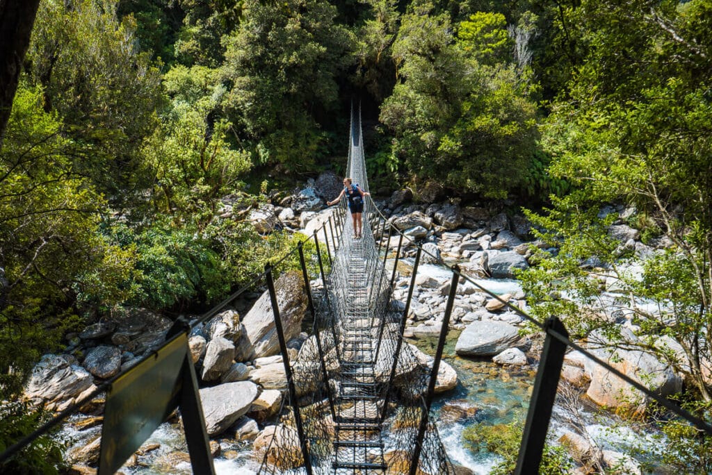 Suspension bridge crossing a river on the Copland Track in New Zealand
