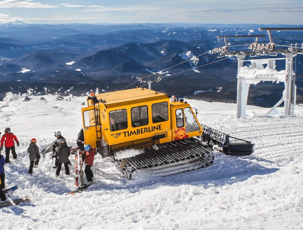 Palmer Snowcat with skiers standing in the snow at Timberline Lodge in Oregon