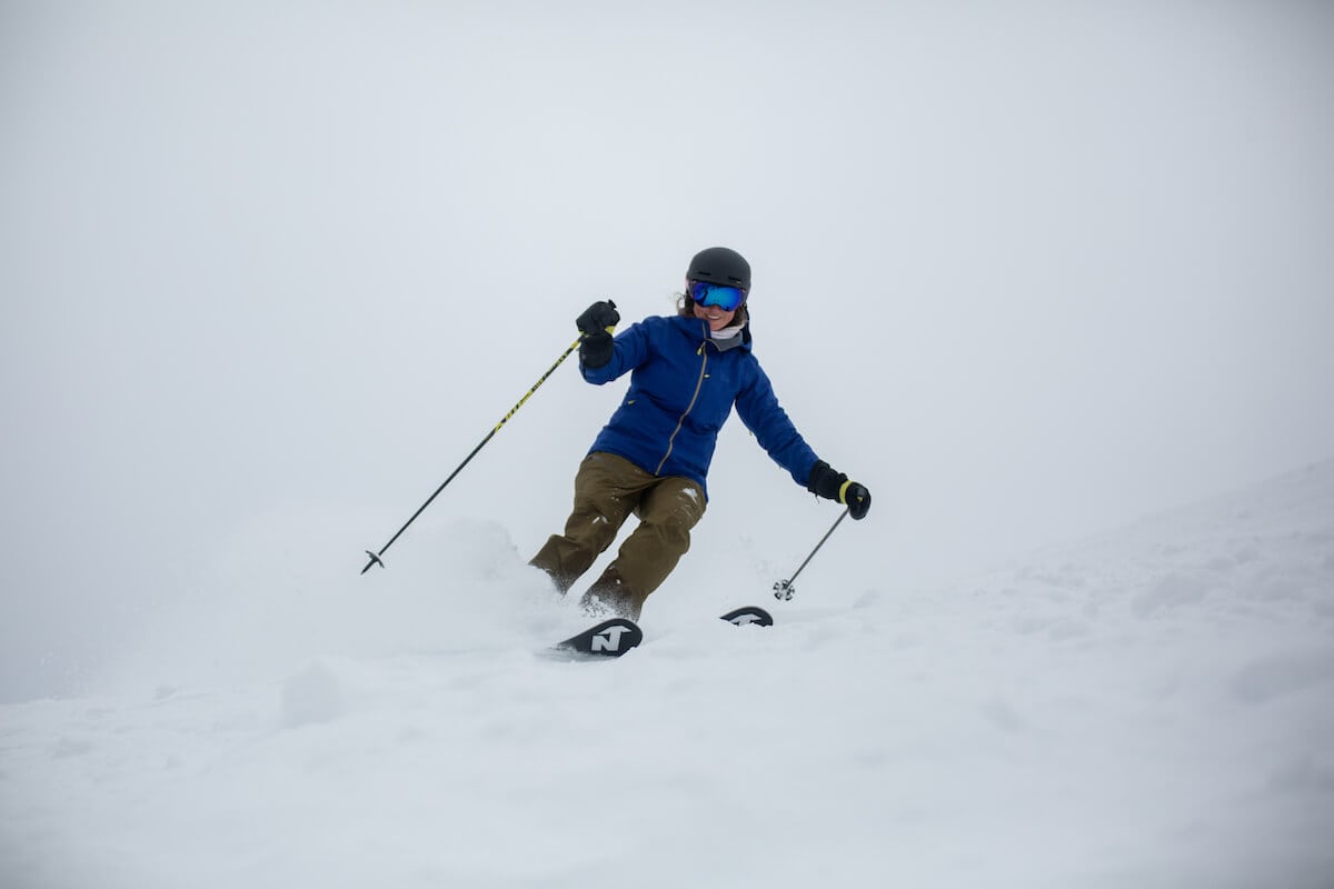 Skier skiing down snowy slope