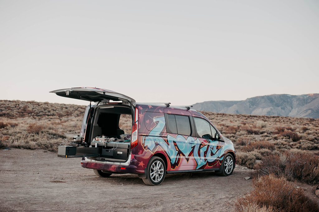 Escape Campervans Santa Cruz model van in front of a desert landscape // Enter to win a 4-day camper van rental with everything you need for an epic road trip.