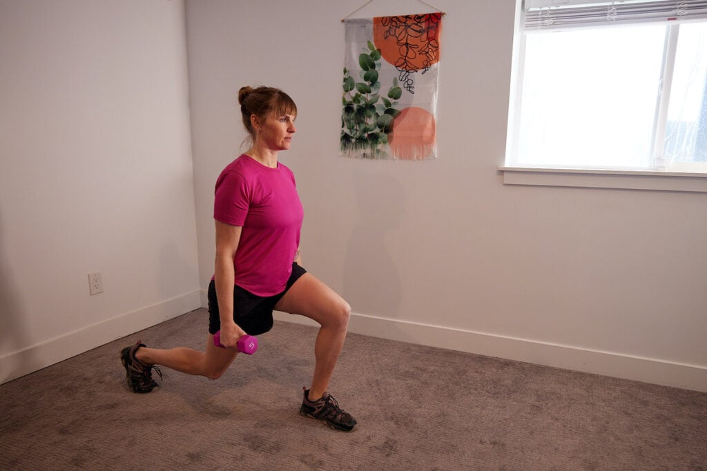 Woman doing lunges at home wearing the lululemon Track That Mid-Rise Lined Short