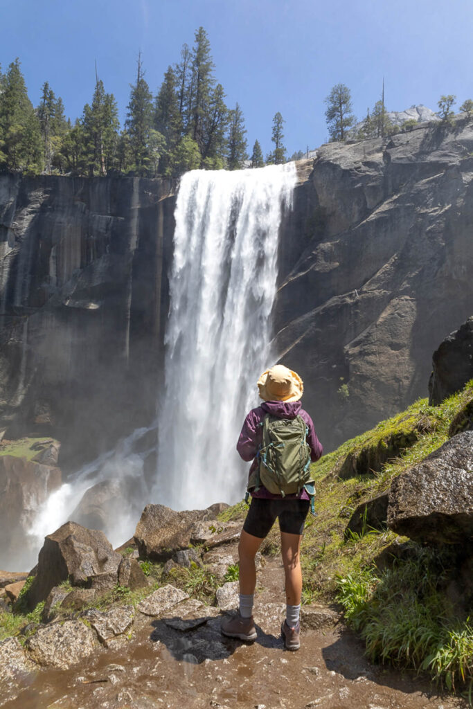 Woman standing in front of a waterfall 